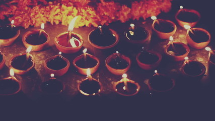 Indian traditional oil lamp symbolizing spreading of light and end of darkness, retro style