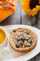 Healthy food - pumpkin vegetable soup and  bread with Chia seeds,  soy bean, pumpkin, pine and sunflower seeds