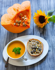 Healthy food - pumpkin vegetable soup and  bread with Chia seeds,  soy bean, pumpkin, pine and sunflower seeds