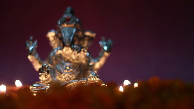 lord ganesha with clay oil lamp and flowers, space for text