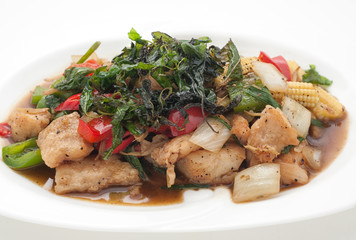 Fried fish with basil leaves isolated on white