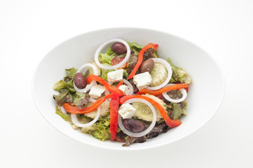 Greek salad with slices of paprika isolated on white
