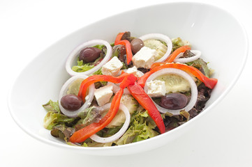 Greek salad with slices of paprika isolated on white