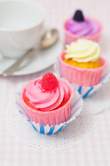 Three cupcakes and a tea cup