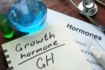growth hormone written on notebook. Test tubes and hormones list. - obrazy, fototapety, plakaty