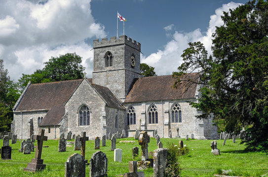 Quintessential English village church and cemetery on a summers afternoon. 