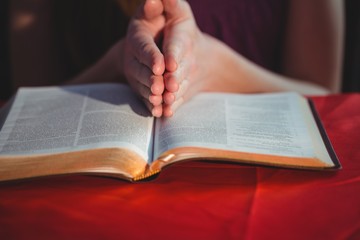 Fototapeta premium Woman praying with her bible