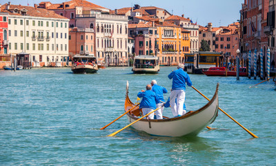 Gondolier gondola on Grand canal Venice Italy