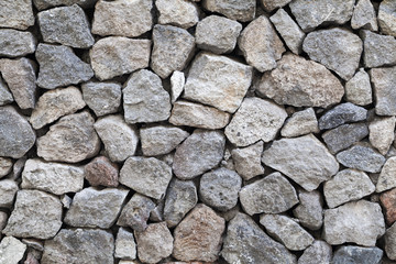 Textuur van grijze ruwe granieten stenen muur