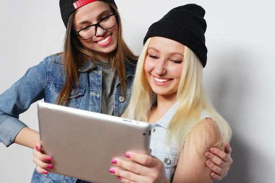  girls taking a self portrait with a tablet