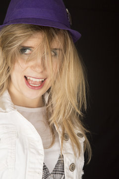 Woman wearing a purple hat with crazy hair