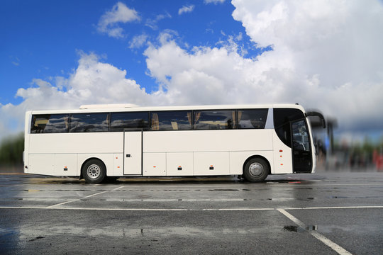White Coach Bus Waits for Passengers on Foggy  Morning