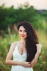 Happy woman in spring field. Young girl relax outdoors. Freedom