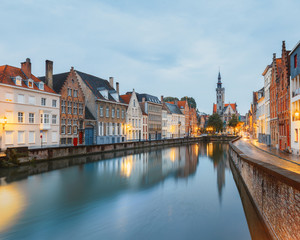 Fototapeta na wymiar Jan van Eyck Square over the waters of Spiegelrei, Bruges