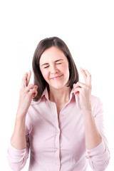 Fototapeta premium Young businesswoman making a wish, isolated on white background.