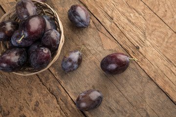 damson plums on wooden table