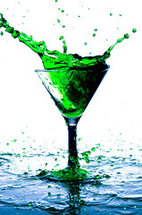 splash in a glass with a green drink