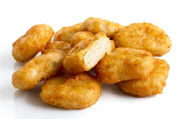 Fototapeten Pile of golden deep-fried battered chicken nuggets isolated on w © Moving Moment