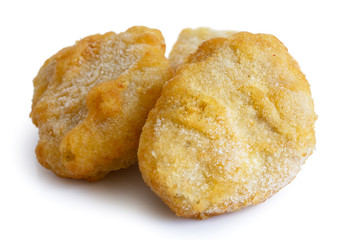 Frozen battered chicken nuggets uncooked and isolated on white i