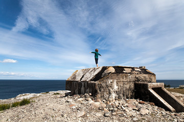 Swedish Baltic Sea, over two hundred years of peace. Child on top of old bunker.