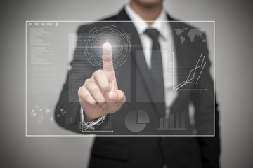 Close up of businessman touching digital screen with finger