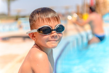 Smiling little boy in swimming goggles