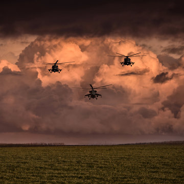 Group combat helicopters, Mi-24, Mi-8 on a background of clouds
