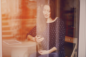 beautiful young girl enjoys phone and tablet