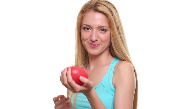Young slim woman holding a red juicy tomato.