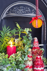 A christmas fire side display with a Christingle decoration
