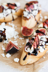 Bruschetta with figs,goat cheese and balsamic sauce.selective focus