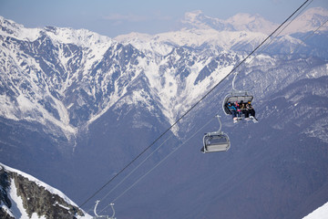 Skiers and snowboarders on a ski lift