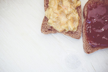 toasted wholemeal crisp bread with jam on a bright wood background