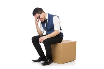 Young employee sitting on the box isolated on white