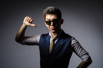 Young man in blue vest against gray
