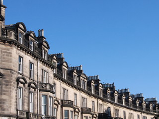 Fototapeta na wymiar Row of houses in Edinburgh against blue sky