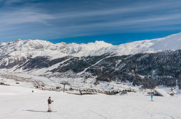 Naklejka na ściany i meble Skiers on the slope of Ski resort Livigno. Italy