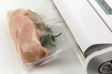 Fresh chicken breast in bag under vacuum; sou vide - cooking under vacuum