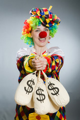 Clown with money bag in funny concept