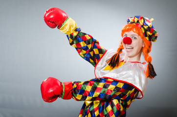 Clown with boxing gloves isolated on white