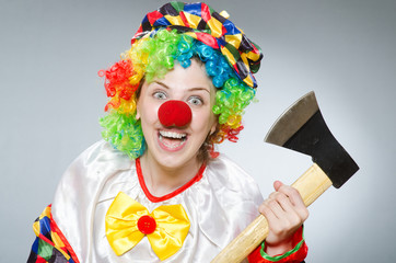 Clown with axe in funny concept