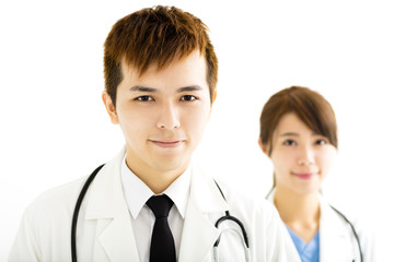 smiling male and female doctors standing together