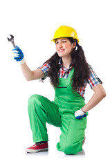 Female workman in green overalls holding key isolated on white