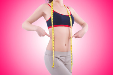 Young girl with centimeter in dieting concept