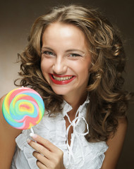 Young woman with colorful lollipop 