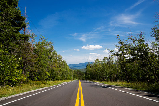 Winding road in Adirondack mountains, upstate New York, USA. Transportation, travel, explore, vacation, summer, destination, driving and nature concept