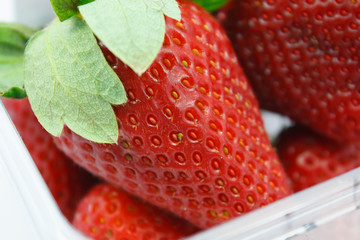 red strawberries in plastic container