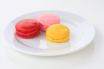 Sweet and colourful french macarons on white table
