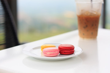 Sweet and colourful french macarons on white table