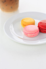 Sweet and colourful french macarons on white table
